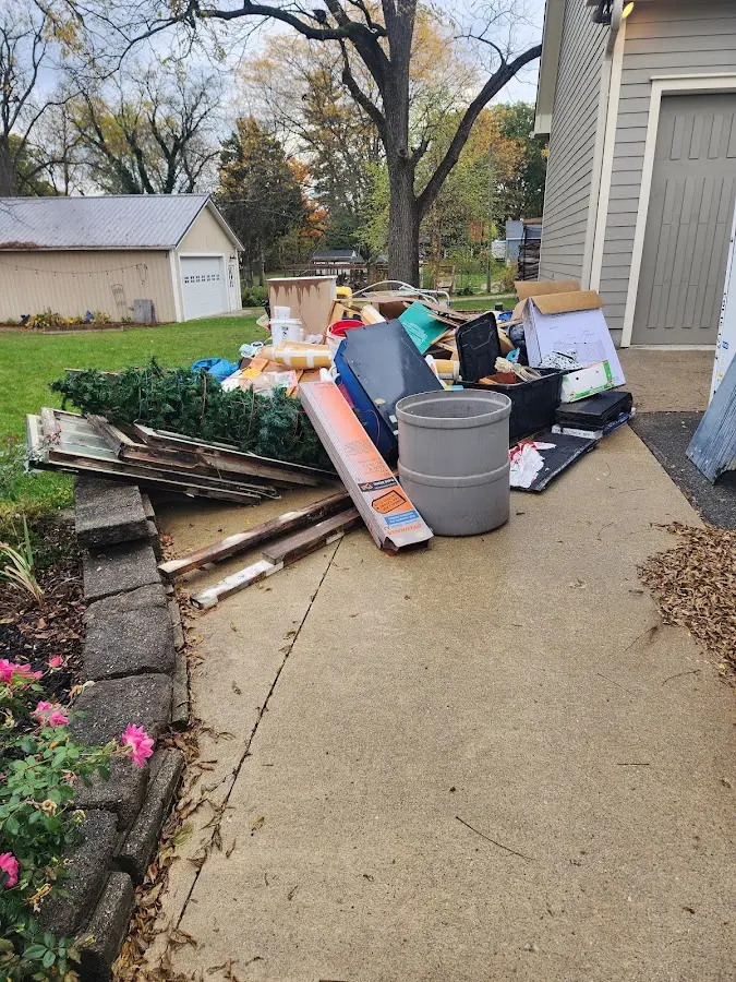 Dumpster being loaded with debris for Estate Cleanout Dumpster Rental in Knob Noster